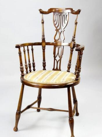 An Edwardian beech high back saloon chair