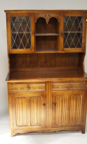 A reproduction linen fold oak dresser