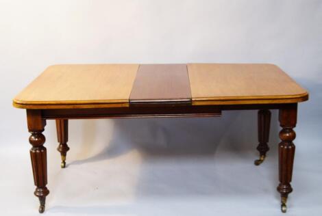 A Victorian mahogany wind-out dining table