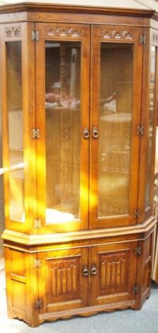 A large modern carved oak corner display cabinet