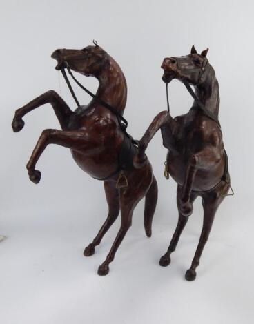 A pair of leather rearing horses