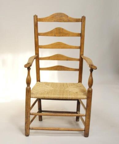 A 19thC rattan seated oak ladderback open armchair.