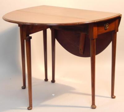 A walnut oval dropleaf table