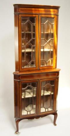 An Edwardian Sheraton Revival standing corner cabinet