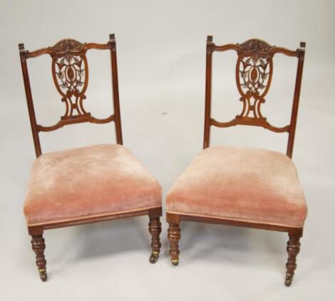 A pair of Victorian walnut nursing chairs