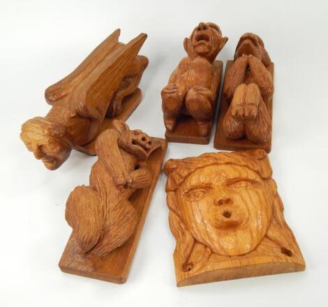 A collection of modern carved oak grotesque gargoyle carvings