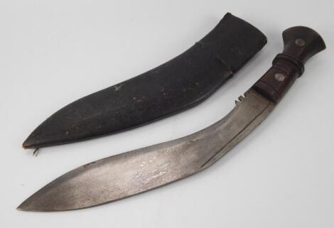 A Khukuri knife with leather scabbard.