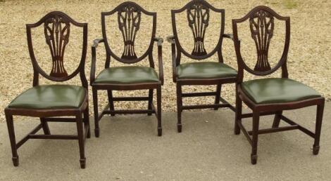 A set of four reproduction mahogany shield back dining chairs