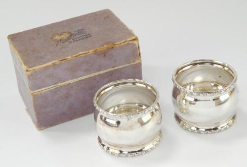 A pair of George VI silver napkin rings