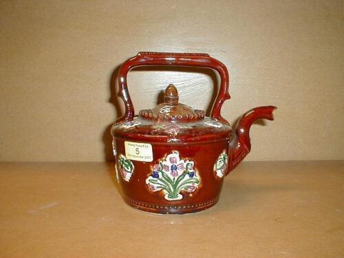 A Bargeware kettle moulded in relief with flowers