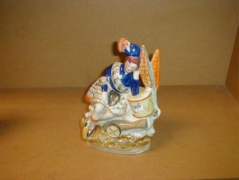 A 19thC pottery Staffordshire figure of a soldier resting against a drum with flags