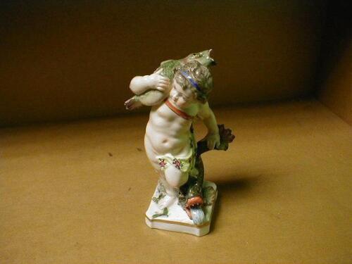 RTV A 19thC Samson figure of a putti standing with one foot on the back