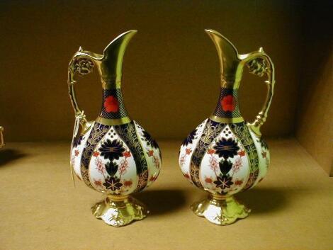 A pair of Royal Crown Derby ewers