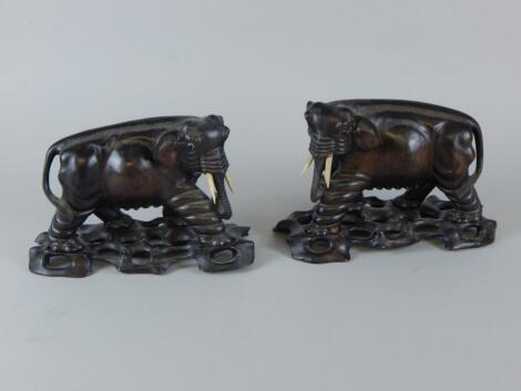 A pair of Chinese hardwood figures of elephants