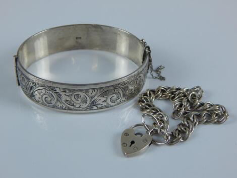 A silver bangle and charm bracelet