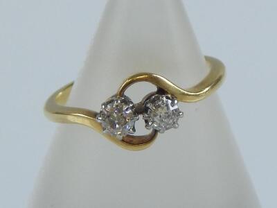 A crossover double diamond set ring