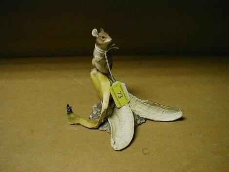 A Border Fine Arts model of a doormouse seated on top of a banana skin