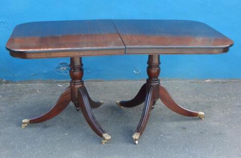 A reproduction mahogany dining table