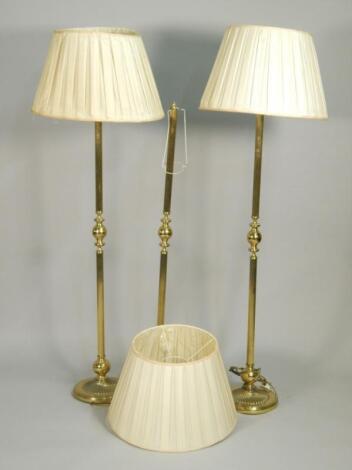 A set of three brass column type standard lamps