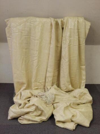 A pair of pale gold damask lined and interlined curtains