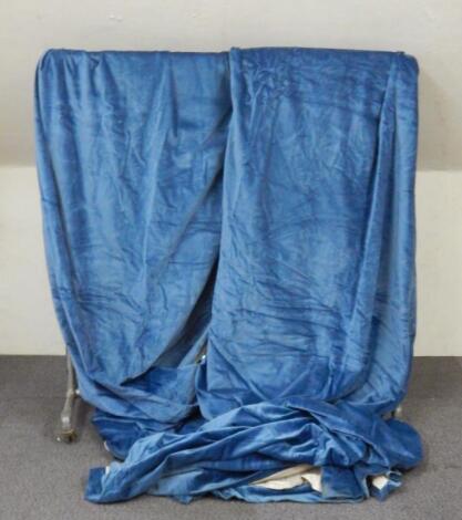 A pair of blue velvet full length lined curtains