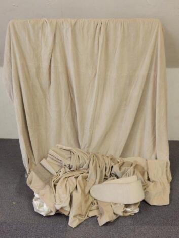 A single beige full length velvet lined curtain