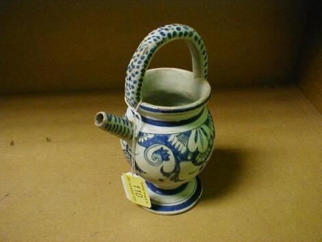 A Delft flagon, painted with blue foliate scroll and flowers, with overhead