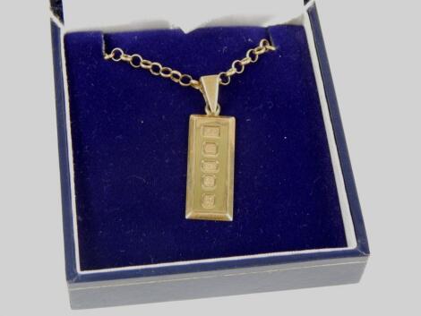 A 9ct gold ingot pendant and chain