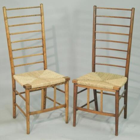 A pair of late 19thC / early 20thC oak ladderback Arts and Crafts style chairs