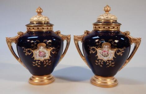 A pair of early 20thC Coalport porcelain vases