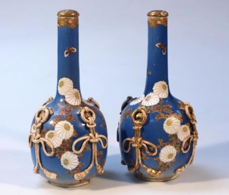 A pair of 20thC Japanese earthenware bottle vases and stoppers