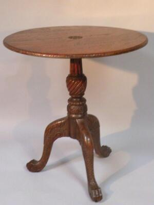 An early 20thC oak tripod table