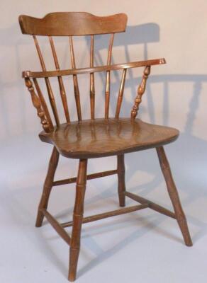 A 19thC style child's beech comb back Windsor chair