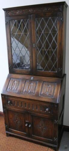 A Jaycee oak linen fold bureau bookcase