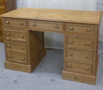 A stripped and lightly polished pine pedestal desk