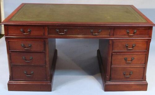 An early 20thC mahogany twin pedestal writing desk