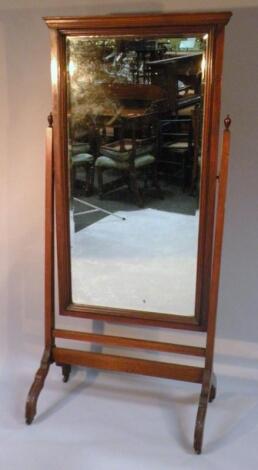 An Edwardian mahogany cheval mirror