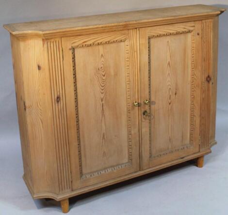 A stripped pine side cabinet