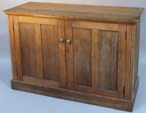 A late 19thC plank top oak cupboard