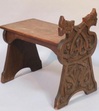 A heavily carved Jacobean style stool