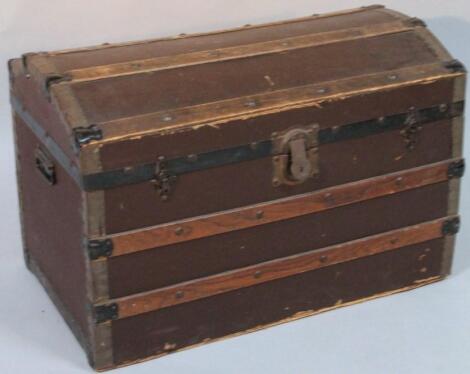 An early 20thC pressed leather oak and part metal bound domed topped trunk