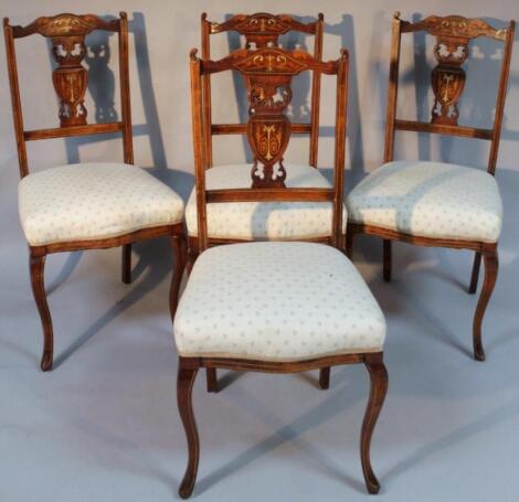 A set of four Edwardian mahogany bone inlaid and boxwood strung dining chairs