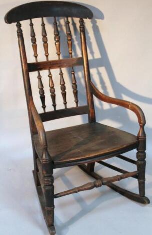 A 19thC ash and elm comb back kitchen rocking chair