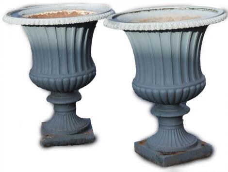 A pair of Victorian cast iron garden urns