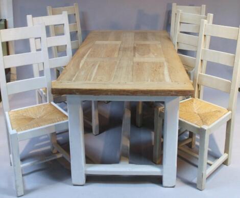 A 20thC light oak plank top refectory style dining table