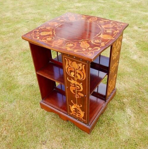 An Art Nouveau mahogany and marquetry revolving book stand