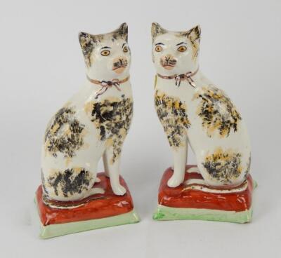 A pair of Staffordshire style cats