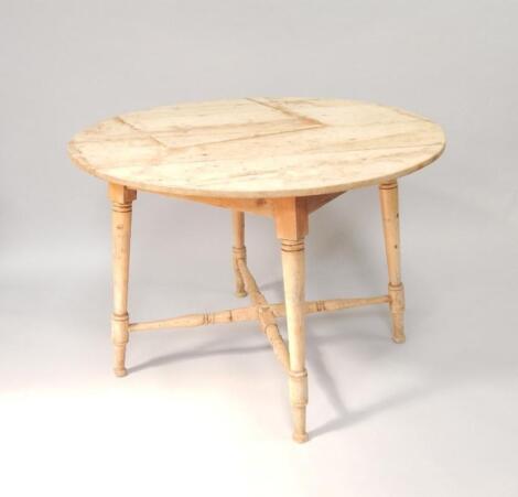 A Victorian circular stripped pine kitchen table
