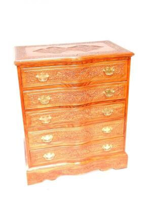 A mahogany serpentine fronted carved chest of drawers