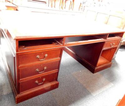 A reproduction mahogany partners desk